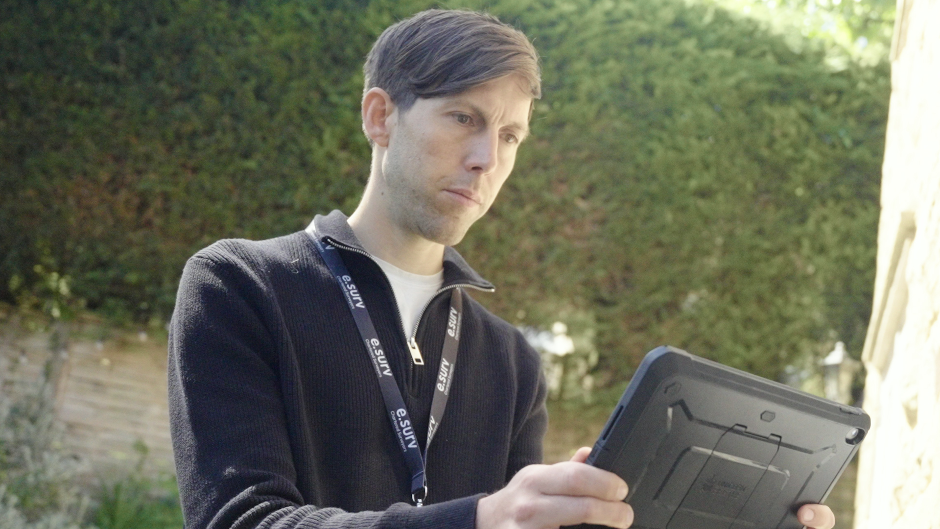 e.surv surveyor using a tablet to carry out a residential property inspection